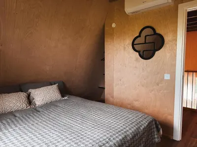 a bedroom with a bed with a black sign on the wall at Mulberynas in Stakliškės