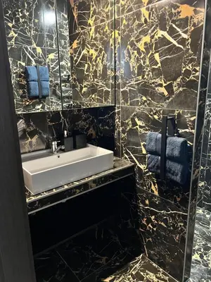 a bathroom with a sink and a mirror at Jaukūs , modernūs apartamentai in Raseiniai