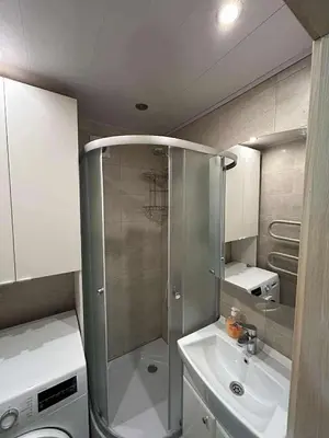 a small bathroom with a shower and a sink at ROŽĖS BUTAS Apartment in Raseiniai