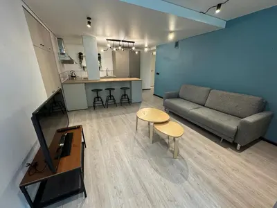 a living room with a couch and a table at Charming & Central City Escape - Close to Transport in Vilnius