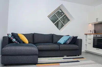 a living room with a couch in a kitchen at Rami erdvė šalia miško ir ežero darbui ir poilsiui in Trakai