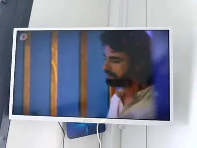 a television with a picture of a man at Pas Alksnius in Šiaudinė