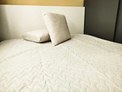 a white bed with a pillow on top of it at Cozy A Noko Apartment in Murava