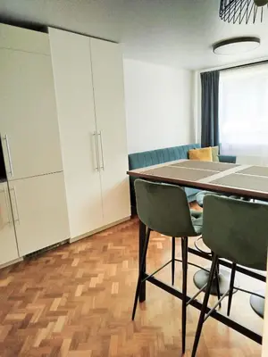 a dining room with a table and two chairs at Cozy A Noko Apartment in Murava