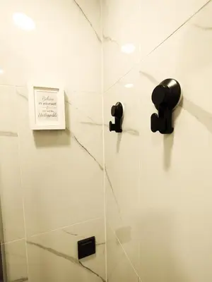 a glass shower stall with a sign on it at Cozy A Noko Apartment in Murava