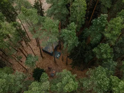 an overhead view of a tent in a forest at Miško terapija in Kriviliai