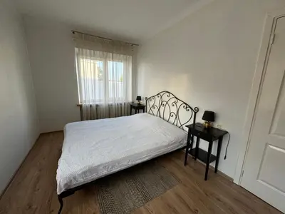 a bedroom with a bed with white sheets and a window at Spacious apartment in Old Town Vilnius street in Vilnius