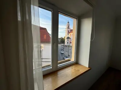 a window with a view of a city street at Spacious apartment in Old Town Vilnius street in Vilnius