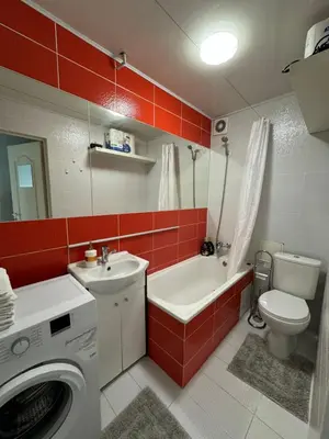 a bathroom with a toilet sink and a washing machine at Spacious apartment in Old Town Vilnius street in Vilnius
