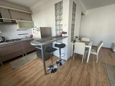 a kitchen with a table and chairs in a kitchen at Spacious apartment in Old Town Vilnius street in Vilnius