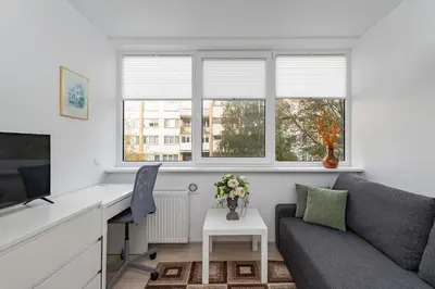 a living room with a couch and a desk at Pramones apartment #1 by PoloApartments in Kaunas