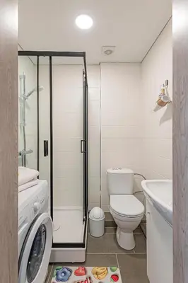 a bathroom with a shower and a toilet and a sink at Pramones apartment #1 by PoloApartments in Kaunas