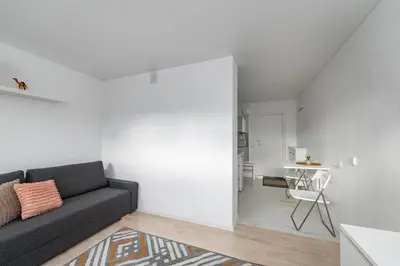 a living room with a couch and a table at Pramonės Apartment #5 by PoloApartments in Kaunas
