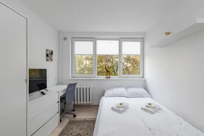 a bedroom with a bed and a desk and window at Pramonės Apartment #6 by PoloApartments in Kaunas
