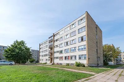 an apartment building on a street with a car parked in front at Pramonės Apartment #6 by PoloApartments in Kaunas