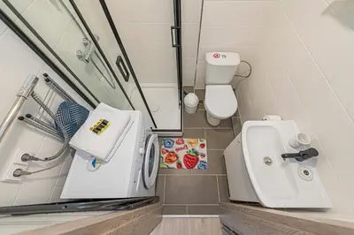 a small bathroom with a toilet and a sink at Pramonės Apartment #7 by PoloApartments in Kaunas