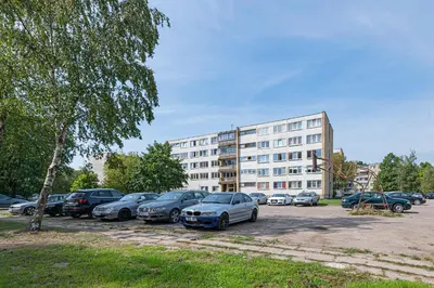 a parking lot with cars parked in front of a building at Pramonės Apartment #7 by PoloApartments in Kaunas