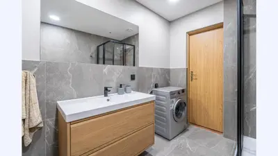 a bathroom with a sink and a washing machine at Sv1 Amber Oldtown SELF CHECK-IN by QuarterStays in Vilnius