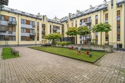 a courtyard of a building with a playground in front at Sv1 Amber Oldtown SELF CHECK-IN by QuarterStays in Vilnius