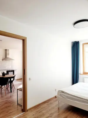 a bedroom with a bed and a dining room at Sv1 Amber Oldtown SELF CHECK-IN by QuarterStays in Vilnius