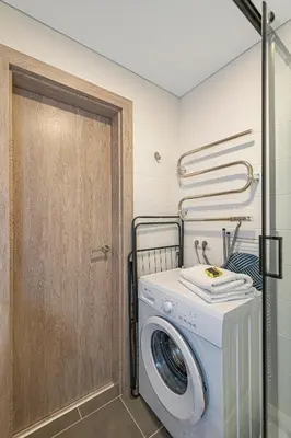 a washer and dryer in a laundry room at Pramonės Apartment #8 by PoloApartments in Kaunas