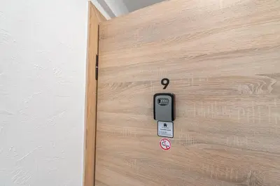 an open door with a cell phone on it at Pramonės Apartment #8 by PoloApartments in Kaunas