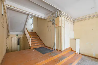 an empty room with a staircase in a building at Pramonės Apartment #8 by PoloApartments in Kaunas