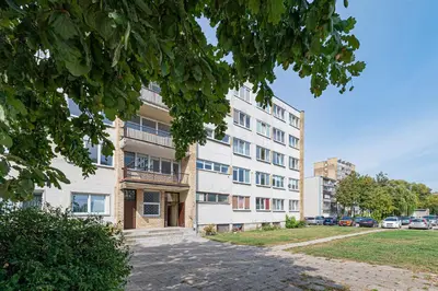 an apartment building with a sidewalk in front of it at Pramonės Apartment #8 by PoloApartments in Kaunas