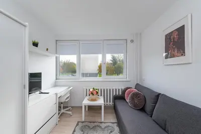 a living room with a couch and a desk at Pramonės Apartment #9 by PoloApartments in Kaunas