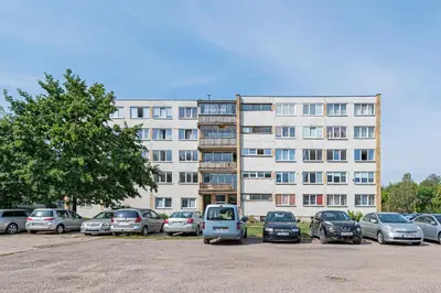 a parking lot with cars parked in front of a building at Pramonės Apartment #9 by PoloApartments in Kaunas