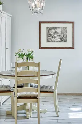 a dining room with a table and chairs and a chandelier at Elegant apartment in Old town Vilnius SELF CHECK IN 24x7 by H&H in Vilnius