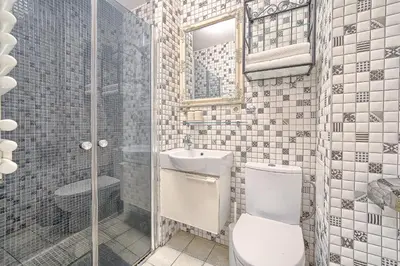a bathroom with a toilet and a sink and a shower at Elegant apartment in Old town Vilnius SELF CHECK IN 24x7 by H&H in Vilnius