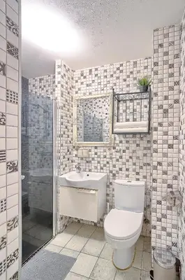 a bathroom with a toilet and a sink at Elegant apartment in Old town Vilnius SELF CHECK IN 24x7 by H&H in Vilnius