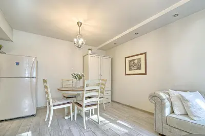 a kitchen and dining room with a table and a couch at Elegant apartment in Old town Vilnius SELF CHECK IN 24x7 by H&H in Vilnius