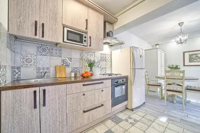 a kitchen with a sink and a refrigerator at Elegant apartment in Old town Vilnius SELF CHECK IN 24x7 by H&H in Vilnius