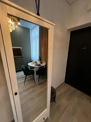 a dining room with a table and a mirror at Chic Residence apartament 1 in Šiauliai