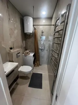 a bathroom with a shower and a toilet and a sink at Chic Residence apartament 1 in Šiauliai