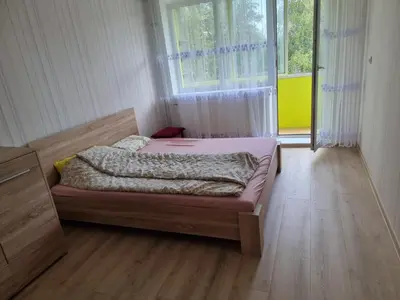 a bedroom with a bed in a room with a window at Kaunas 174 in Murava