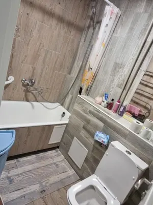 a bathroom with a toilet and a sink and a tub at Kaunas 174 in Murava