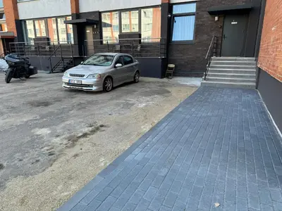 a small silver car parked in a parking lot at Chic Residence apartament 3 in Šiauliai