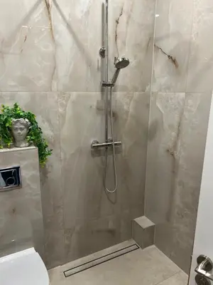 a shower with a glass door in a bathroom at Chic Residence apartament 4 in Šiauliai