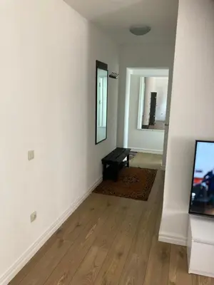 a living room with a table and a mirror at White & Black in Šiauliai