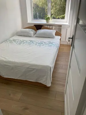 a bed in a small room with a window at White & Black in Šiauliai