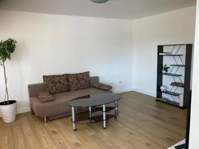 a living room with a couch and a table at White & Black in Šiauliai
