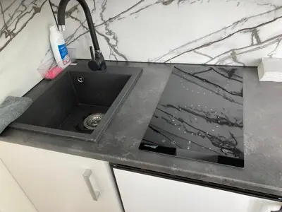 a kitchen counter with a sink in a kitchen at White & Black in Šiauliai