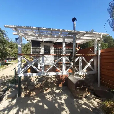 a house with a white gate and a fence at Dvivietis namelis su ofuro vone in Esperanza