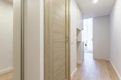 a hallway with a wooden door in a house at Loft G57 in Vilnius