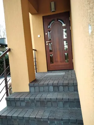 a front door of a house with stairs leading to it at Green Garden Apartments in Kaunas