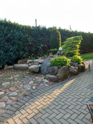 a garden with a bunch of rocks and plants at Green Garden Apartments in Kaunas