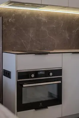 a kitchen with a black and white oven at Old Town - Bajor Studios - Self Check-in and Parking in Kaunas